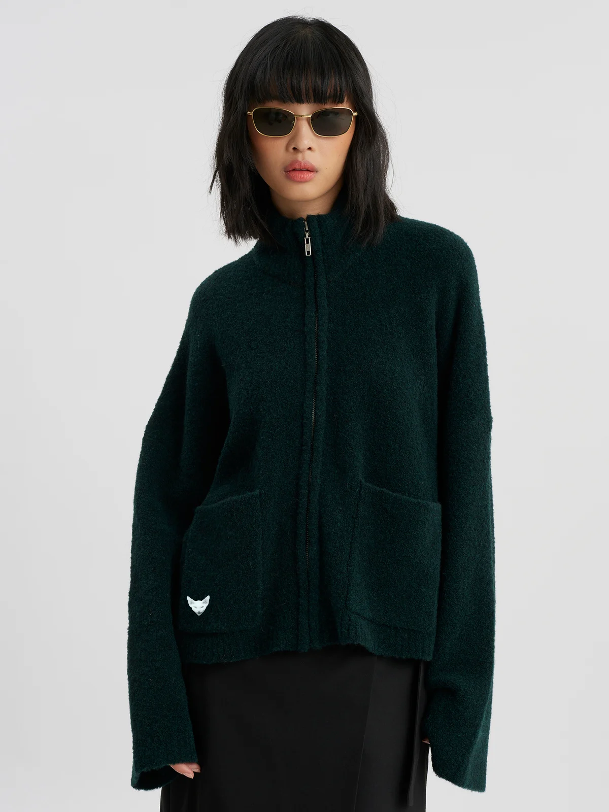 woman wearing darkgreen zip cardigan
