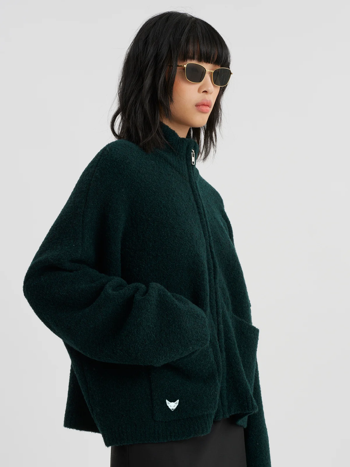 woman wearing darkgreen zip cardigan