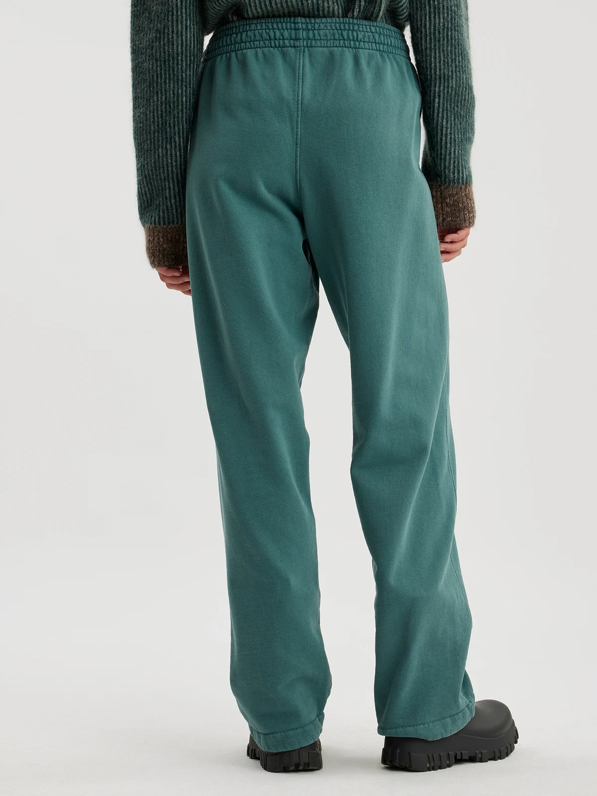 Woman wearing forest green joggers
